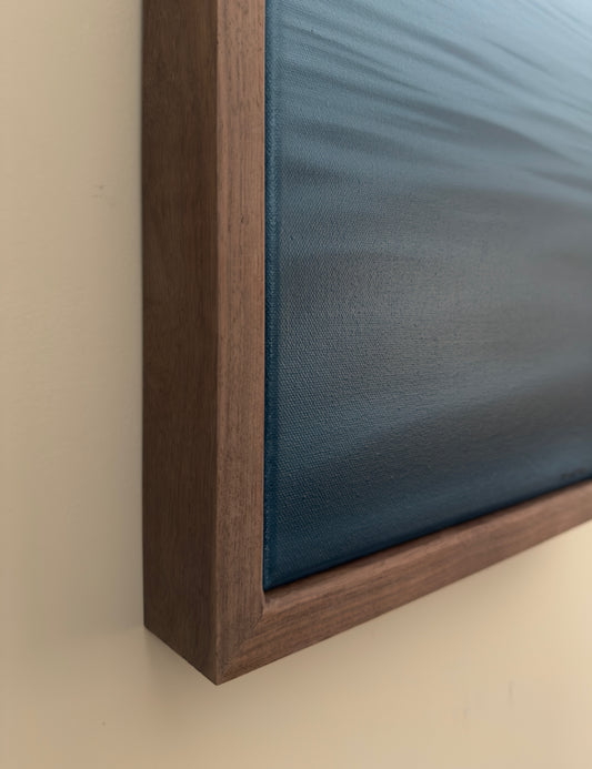 Wooden frame with a blue panel on a beige background