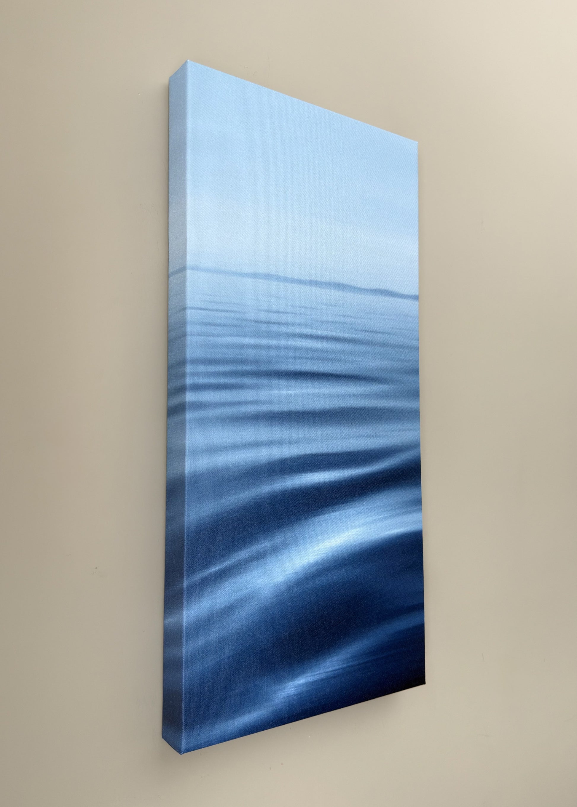 Abstract blue artwork on a beige wall