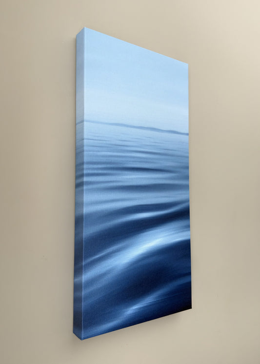 Abstract blue artwork on a beige wall