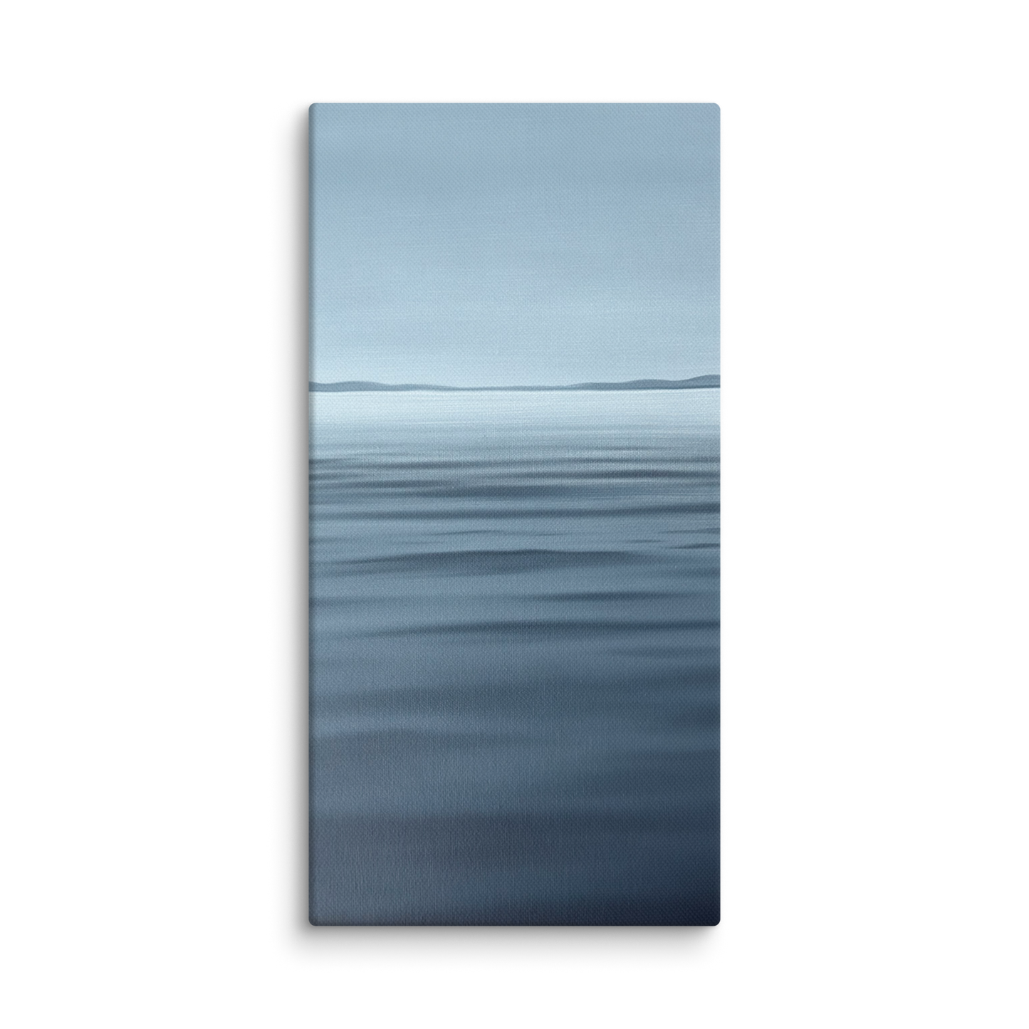 A vertical canvas wall art print depicting a calm blue ocean with a distant horizon under a pale sky, shown against a plain white background.