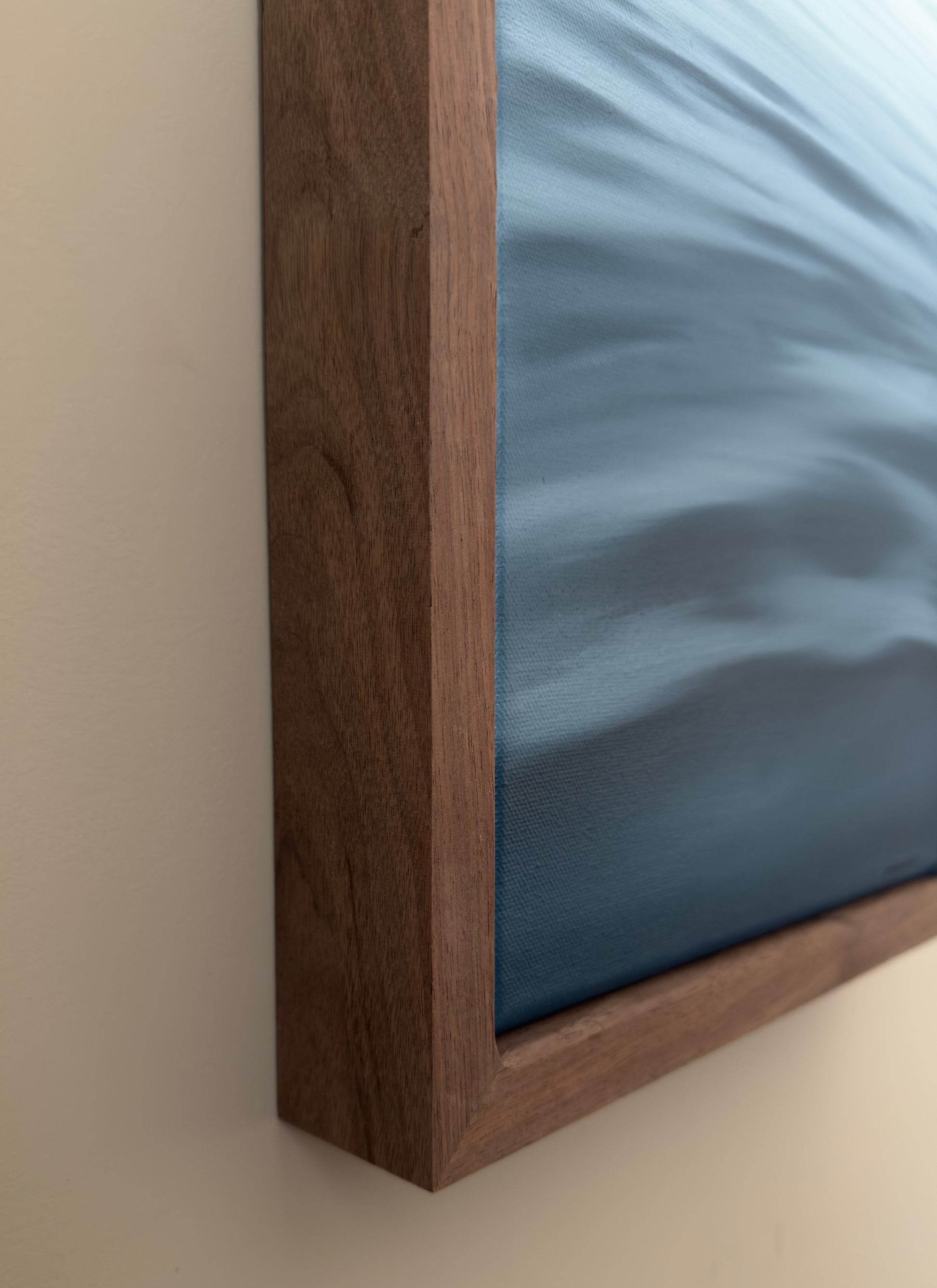 Close-up of a wooden frame with a blue canvas background